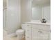Bathroom featuring a white vanity with double sinks, a toilet, and a tile shower at 2846 Snead Ne Ct, Conover, NC 28613