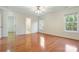 Bedroom featuring hardwood floors, two windows, ceiling fan, and an ensuite bathroom at 2846 Snead Ne Ct, Conover, NC 28613