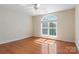 Cozy bedroom with hardwood floors and a large arched window providing ample natural light and neighborhood views at 2846 Snead Ne Ct, Conover, NC 28613