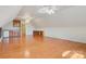 Large bonus room with hardwood floors, built-in shelving, and a wet bar, perfect for entertaining and relaxation at 2846 Snead Ne Ct, Conover, NC 28613
