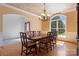 Formal dining room featuring hardwood floors, a large window, and an elegant chandelier over a wooden table at 2846 Snead Ne Ct, Conover, NC 28613