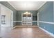 Dining room featuring green walls, white trim, tile floors, and an elegant chandelier under a window at 2846 Snead Ne Ct, Conover, NC 28613