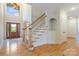 Bright foyer with hardwood floors, a staircase, a decorative front door, and an arched doorway at 2846 Snead Ne Ct, Conover, NC 28613