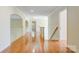 Hallway featuring hardwood floors, archways, and a staircase to the second level at 2846 Snead Ne Ct, Conover, NC 28613