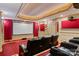 Home theater with tiered leather recliners, a large screen, and soundproofing panels for an immersive viewing experience at 2846 Snead Ne Ct, Conover, NC 28613