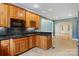 A bright kitchen featuring wood cabinetry, a wine rack, granite countertops, and an open view to the dining area at 2846 Snead Ne Ct, Conover, NC 28613