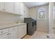 Well-equipped laundry room with modern washer and dryer, ample cabinet space, and a sink for convenience at 2846 Snead Ne Ct, Conover, NC 28613