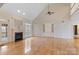 Bright living room featuring hardwood floors, a fireplace, built-in cabinets, and large windows overlooking the yard at 2846 Snead Ne Ct, Conover, NC 28613