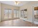 Light-filled sunroom with multiple windows, tile flooring, ceiling fan, and a view of the backyard and patio at 2846 Snead Ne Ct, Conover, NC 28613