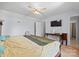 Bedroom featuring a ceiling fan, mounted television, and a view to the ensuite bathroom at 311 S Cedar St # C, Lincolnton, NC 28092