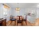 Cozy dining area with a wood table, chandelier, and natural light from the nearby window at 311 S Cedar St # C, Lincolnton, NC 28092