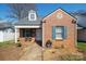 Charming brick home with a dormer window, blue shutters and covered front porch at 311 S Cedar St # C, Lincolnton, NC 28092
