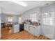 Well-lit kitchen with white cabinets, stainless sink, black dishwasher and adjacent eat-in dining area at 311 S Cedar St # C, Lincolnton, NC 28092
