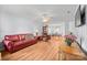Open-concept living room with laminate floors, leather furniture and ceiling fan at 311 S Cedar St # C, Lincolnton, NC 28092