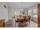 Well-lit dining room featuring classic chairs, an elegant light fixture, and hardwood flooring at 329 N Ellis St, Salisbury, NC 28144