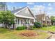 Exterior front elevation showcasing the cozy covered porch and the mature landscaping of this inviting home at 329 N Ellis St, Salisbury, NC 28144