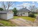 Charming home exterior featuring a well-maintained lawn, detached garage, and inviting curb appeal at 329 N Ellis St, Salisbury, NC 28144