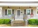 Inviting front porch with ceiling fans, seating, and lush landscaping creates a welcoming entrance at 329 N Ellis St, Salisbury, NC 28144