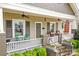 Charming front porch featuring ceiling fans, seating area, and decorative flower boxes at 329 N Ellis St, Salisbury, NC 28144