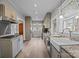 Bright kitchen featuring light gray cabinetry, granite countertops, stainless steel appliances, and hardwood floors at 329 N Ellis St, Salisbury, NC 28144