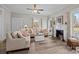 Living room showcasing hardwood floors, fireplace with mantel, and sunlit windows with charming curtains at 329 N Ellis St, Salisbury, NC 28144