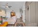 Inviting living room featuring hardwood floors, ceiling fan, and an open doorway to the dining area at 329 N Ellis St, Salisbury, NC 28144