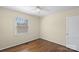 Bright bedroom with wood flooring, ceiling fan, and a window providing natural light at 343 Wakefield Dr # B, Charlotte, NC 28209