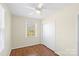 Inviting bedroom with hardwood floors, white closet doors, and window at 343 Wakefield Dr # B, Charlotte, NC 28209