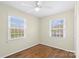 Bright bedroom with hardwood floors, neutral walls, and natural light from two windows at 343 Wakefield Dr # B, Charlotte, NC 28209