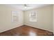 Simple bedroom showcasing hardwood floors and natural light from a window at 343 Wakefield Dr # B, Charlotte, NC 28209