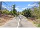 Scenic paved walking path with a center line, surrounded by trees and greenery at 343 Wakefield Dr # B, Charlotte, NC 28209