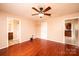 Bedroom with hardwood floors, ceiling fan, and views into the bathroom and kitchen areas at 3628 Laney Rd, Maiden, NC 28650