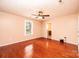 Spacious bedroom featuring hardwood floors, a ceiling fan, and an ensuite bathroom at 3628 Laney Rd, Maiden, NC 28650