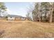 View of home's backyard, featuring a deck and mature trees at 3903 Bon Rea Dr, Charlotte, NC 28226