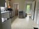 View of the kitchen with white cabinets, stainless steel appliances and neutral color backsplash at 415 W Warren St, Shelby, NC 28150
