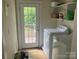 Bright laundry room with washer, dryer, and door leading to the outside at 415 W Warren St, Shelby, NC 28150