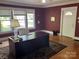 Office space featuring a large desk, natural light, and classic hardwood floors at 415 W Warren St, Shelby, NC 28150