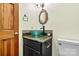 A powder room boasts a striking green vessel sink and granite countertop at 4221 Lake Shore S Rd, Denver, NC 28037