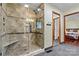 Updated bathroom featuring a tiled shower with a glass door and a built-in bench at 4221 Lake Shore S Rd, Denver, NC 28037