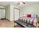 A bedroom with a window and carpet flooring features a full size bed with a padded bench at 4221 Lake Shore S Rd, Denver, NC 28037