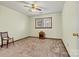 A bedroom features carpet, a window, and a chair at 4221 Lake Shore S Rd, Denver, NC 28037