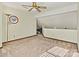 An upstairs bonus room features neutral carpet and a unique architectural ceiling design at 4221 Lake Shore S Rd, Denver, NC 28037