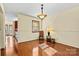 Bright dining area featuring beautiful wood floors, a pendant light fixture, and natural light at 4221 Lake Shore S Rd, Denver, NC 28037