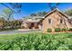 Traditional brick home featuring a well-maintained lawn, a brick and wood staircase, and attached garage at 4221 Lake Shore S Rd, Denver, NC 28037