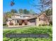 Charming brick home with well-manicured lawn and flowering bushes with an attached two car garage at 4221 Lake Shore S Rd, Denver, NC 28037