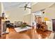 Cozy living room featuring a fireplace, seating, stairs, and hardwood floors at 4221 Lake Shore S Rd, Denver, NC 28037