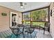 The screened porch features outdoor seating and provides relaxing views of the landscaped backyard at 4221 Lake Shore S Rd, Denver, NC 28037