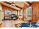 Cozy sunroom with natural light, wood paneling, tiled flooring, and a ceiling fan at 4221 Lake Shore S Rd, Denver, NC 28037