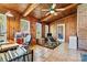 Wood-paneled sunroom with tiled floor, ceiling fan, and access to the outside deck at 4221 Lake Shore S Rd, Denver, NC 28037