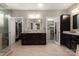 Primary bathroom featuring double vanity, dark wood cabinets, and separate and walk-in closets at 4225 Jasmin May Dr, Charlotte, NC 28226